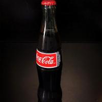 Mexican Coca Cola  · Bottled in Mexico, in the classic glass bottle, made with cane sugar, not high fructose corn...