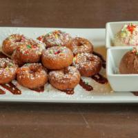 Mini Donut Dunkeroos · fried mini donuts, dusted with powdered sugar, served with Nutella & vanilla frosting for di...