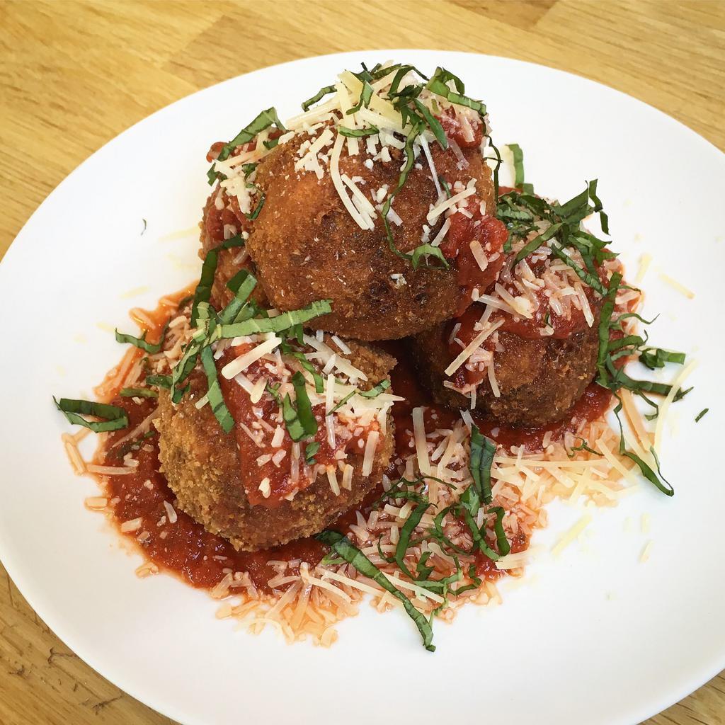 Crispy Risotto Balls · Creamy arborio rice with wild mushrooms and leeks, stuffed with port salut cheese, topped with parmesan, basil, and house marinara (gf)