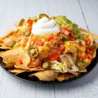 XXX Nachos · Extra loaded homemade corn tortilla chips layered with chicken, beef or barbacoa, lettuce, t...