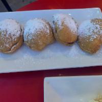 Zeppoli · Fried dough stuffed with nutella and topped with powder sugar.