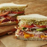 Dub Club Sandwich · Slices of turkey breast topped with smoked ham, bacon, avocado, cheddar cheese, with Erik’s ...