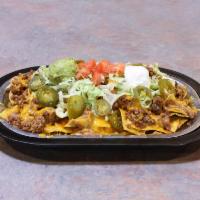 Cindy Nachos · Corn tortilla chips topped with refried beans, ground beef and melted cheddar cheese.