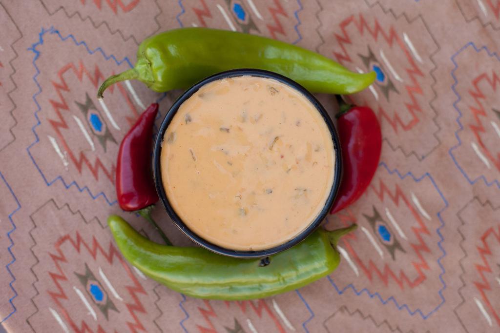 Chile Con Queso · Our green chile with a blend of melted cheeses with tortilla chips.