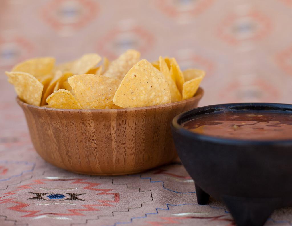 Chips & Salsa · House-made corn tortilla chips with our warm green chile salsa.