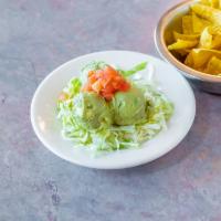 Guacamole Salad · Fresh guacamole atop a bed of lettuce served in a crispy corn tortilla bowl with tomato garn...