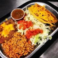 2 Taco Plate · Homemade crispy shells with your choice of filling.  Includes two sides.
