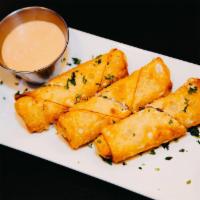 Reuben Egg Rolls · Corned beef, Sauerkraut & Swiss Cheese, rolled up and pan fried, served with a side 1000 Isl...