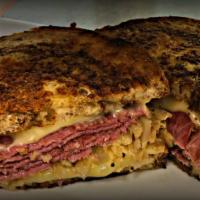 The Reuben Sandwich · Corned beef, Swiss cheese, sauerkraut and 1000 Island served on Parmesan crusted rye bread. ...