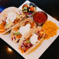 Shrimp Tacos · Perfectly cooked shrimp served on a flour tortilla, topped with shredded cabbage, pico de ga...