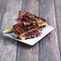 Jims New York Reuben Sandwich · Corned beef, Swiss, kraut and 1000 island on grilled rye. Served with fries and a pickle.