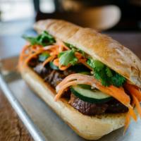 Pork Belly Banh Mi · Soy braised pork belly, pickled carrots, mixed slaw, cilantro, sambal-aioli, french fries or...