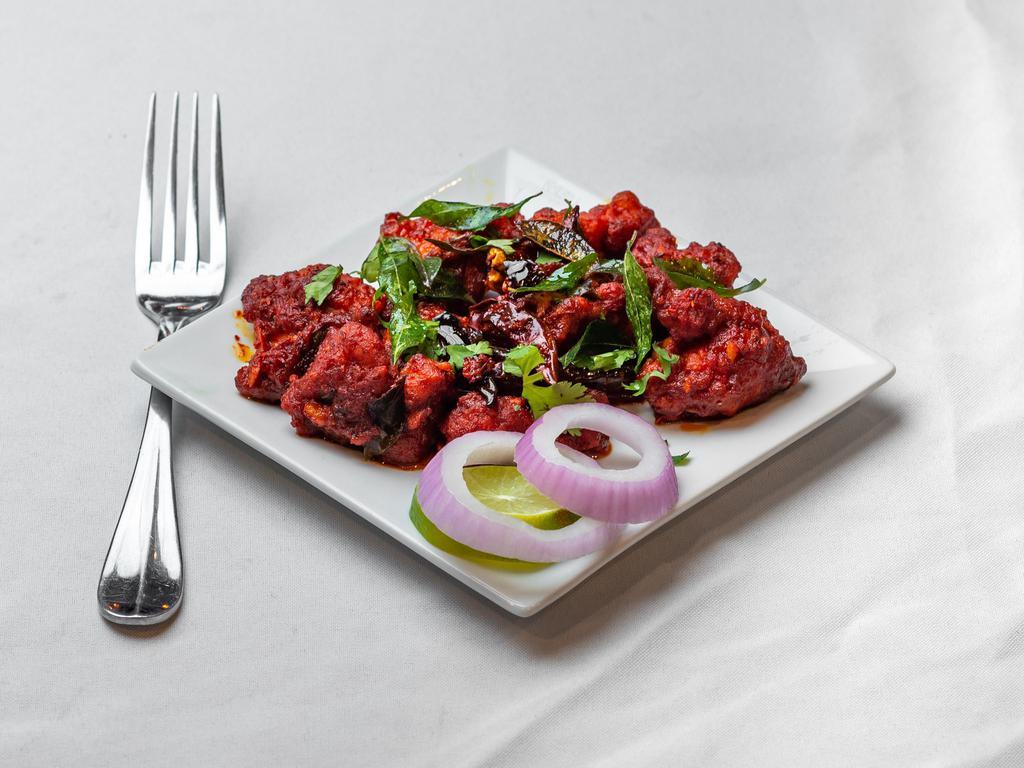 Chicken 65 · Boneless cubes of chicken sautéed in a chef's special 555 sauce with red chili paste.