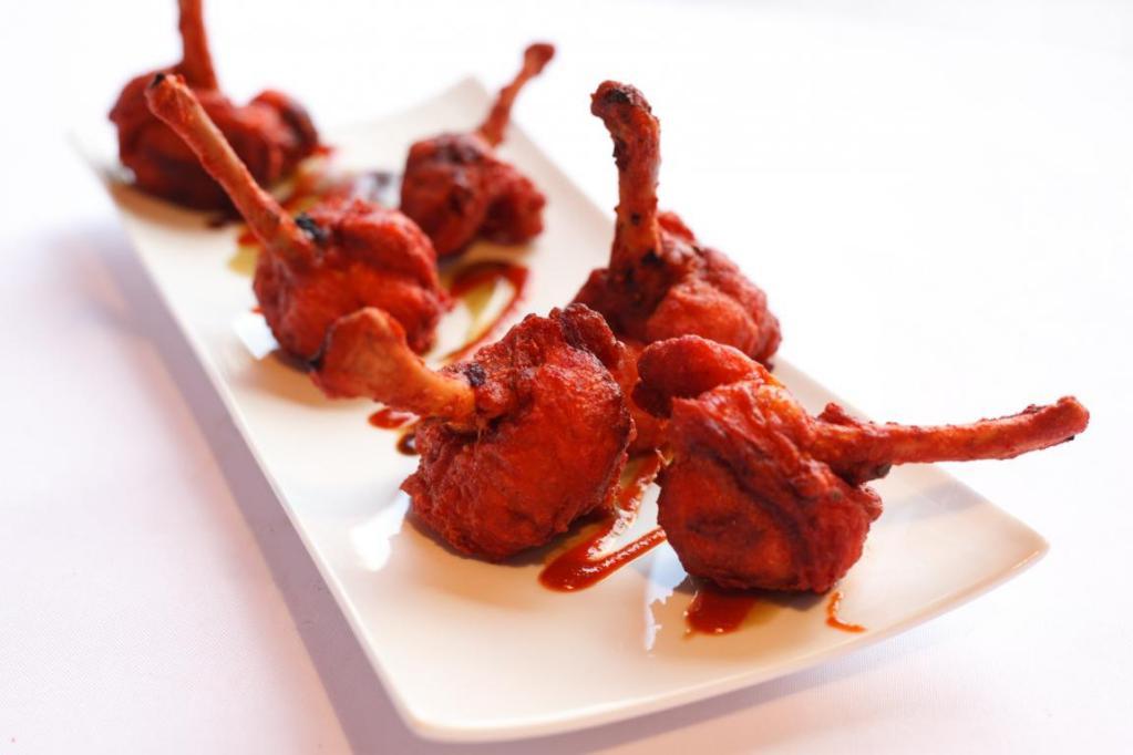 Chicken Lollipops · Marinated chicken wings deep-fried sauteed with spice and herbs.