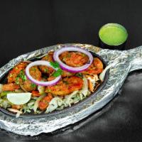 Chicken Tikka Kebab · Boneless cubes of chicken marinated in spices and cream of yogurt glazed in tandoor.