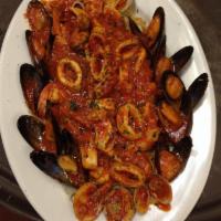 Seafood San Martino · Shrimp, scallops, mussels, clams and calamari on a bed of linguini in a red or white sauce.