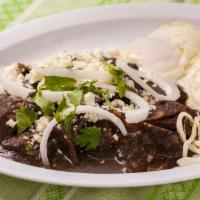 Chilaquiles de Mole Breakfast · Critics favorite. Chilaquiles covered in your choice of either black, red, or coloradito mol...