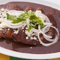 Enfrijoladas · 3 tortillas dipped in a black beans sauce, folded and sprinkled with cheese. Served with a c...