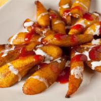 Platanos Fritos · Sliced and fried plantains topped with sour cream walnuts.