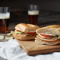 Turkey Classic Sub · Turkey, Wisconsin cheese blend, lettuce, tomatoes, and mayonnaise. Toasted and served with p...
