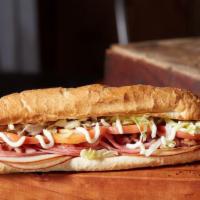 The Club Classic Sub · Ham, turkey, bacon, Wisconsin cheese blend, lettuce, tomatoes, and mayonnaise. Toasted and s...