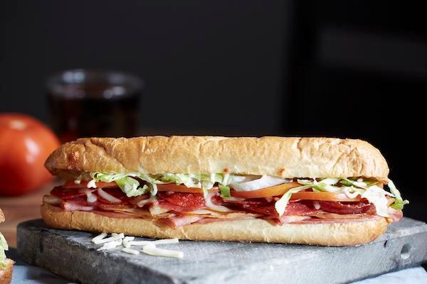The Godfather Premium Sub · Ham, turkey, pepperoni, salami , and Wisconsin cheese blend piled high with lettuce, tomatoes, and mayonnaise. Toasted and served with potato chips.