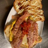 the Bacon on croissant · Bacon, Scrambled Eggs, Swiss Cheese, Red Onions, Teriyaki Glaze, Hot Peppers, Wasabi Mayo on...