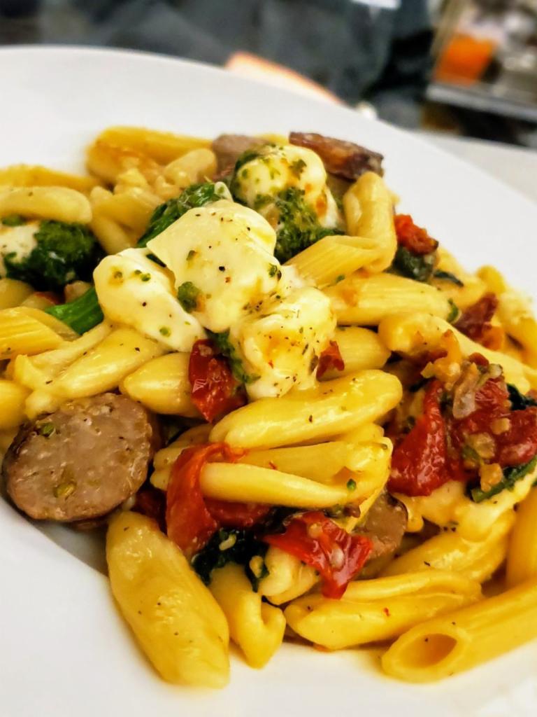 Cavatelli Puteri Pasta · Homemade cavatelli tossed with sauteed sweet Italian sausage, hot cherry peppers, San Marzano tomatoes, broccoli rabe, fresh mozzarella, olive oil and shaved Parmesan cheese.