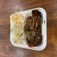 Kalbi Short Ribs · 3 pieces of short rib with sprinkled green onions and sesame seeds over furikake seasoned ri...
