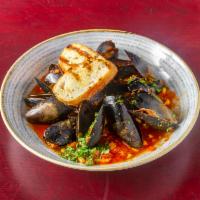 Steamed Blue Mussels · Smokey chorizo, corn, red onions, garlic, tomato broth, grilled bread