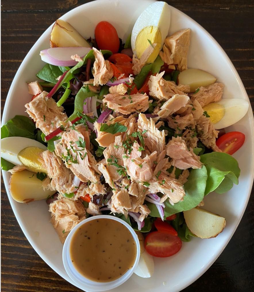 Salade Nicoise · Romaine lettuce, red peppers, hard-boiled egg, onions, tomatoes, haricots verts, potatoes, black olives, and shredded tuna.