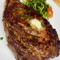 L'Entrecote (Ribeye) · 16oz of Premium beef, served with Mixed Greens Salad, & a side of your choice 