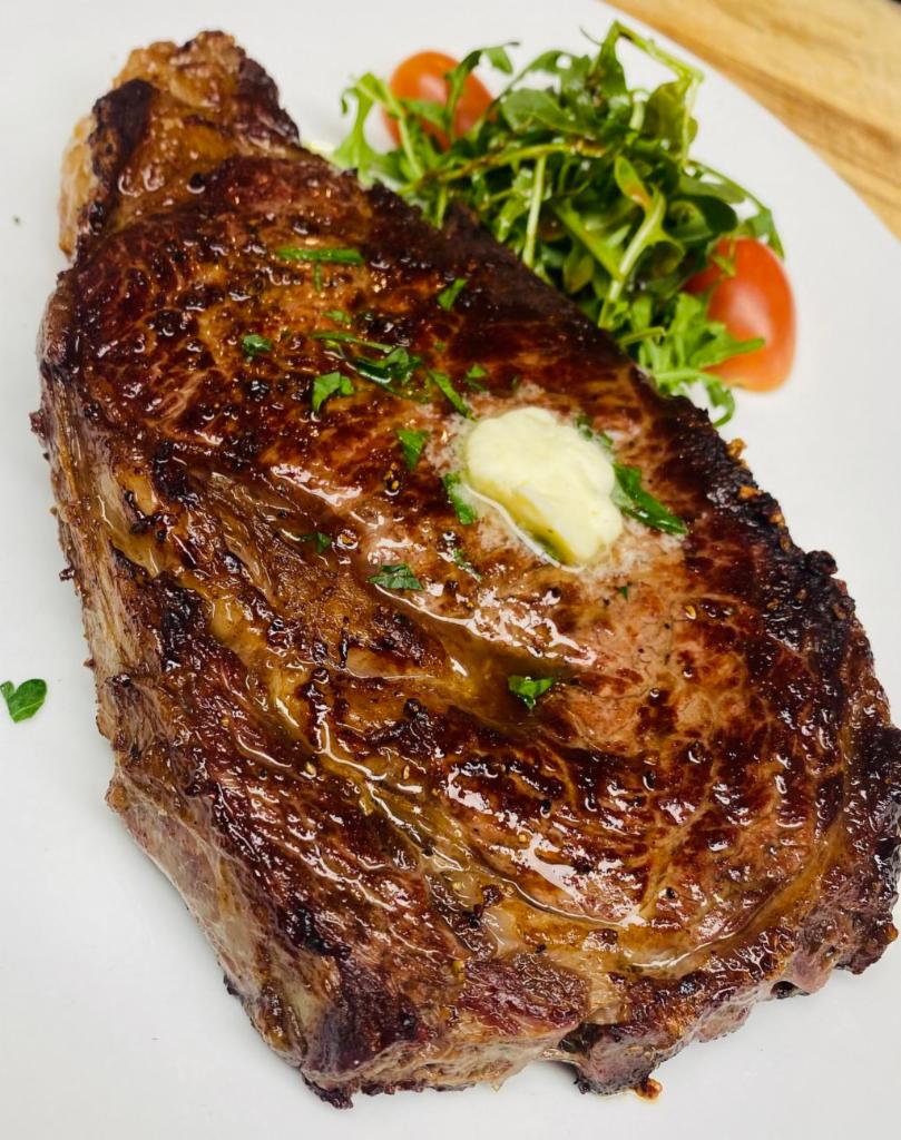 L'Entrecote (Ribeye) · 16oz of Premium beef, served with Mixed Greens Salad, & a side of your choice 