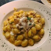 Gnocchi alla Benigni Dinner · Homemade potato dumplings with jumbo shrimp, zucchini and squash in a pesto cream sauce.