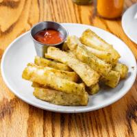 Crispy Yuca Fries · Tossed in garlic oil with banana-habanero ketchup.