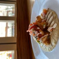 Grilled Shrimp Taco · Guacamole, pico de gallo, and crema.