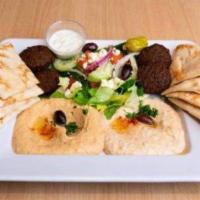 Mediterranean Sampler · A vegetarian delight with Hummus, Baba Ghanoush, Falafels, and Greek Salad