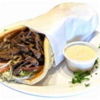 Steak Shawarma Pita · Thinly sliced tri-tip steak, marinated and flame broiled on a vertical skewer, topped with l...