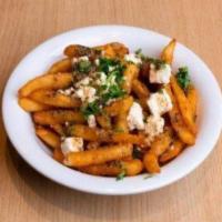 Greek Fries · Our crispy fries topped with feta cheese, and homemade sauce. They are simply irresistible.