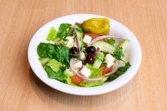 Side Greek Salad · Romaine Hearts, Tomatoes, Onions, Cucumbers, Feta Cheese, Olives, Pepperchini, and Home Made Greek Dressing