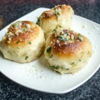 Garlic Knots (3) · House made garlic knots tossed in butter, parsley, garlic, and parmesan. Served with a side ...