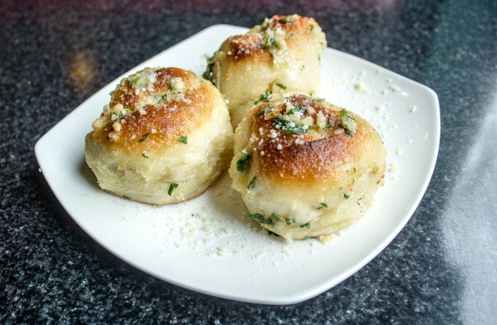 Garlic Knots (3) · House made garlic knots tossed in butter, parsley, garlic, and parmesan. Served with a side of marinara.
