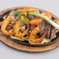 15. Fajitas El Charro Plate · Served beef, chicken fajita and shrimp. Served with rice, beans, pico de gallo and guacamole.