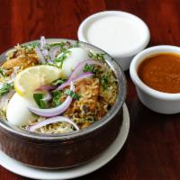 Chicken Biryani · Made with basmati rice, spices and chicken. Chicken is marinated and cooked.