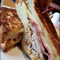 Monte Cristo Sandwich · Thin slices of ham and turkey with Swiss cheese smothered between grilled Challah French Toa...