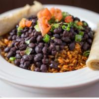 Black Beans and Rice · Slow cooked black beans and rice, our homemade ole sauce, sour cream and warm flour tortillas.