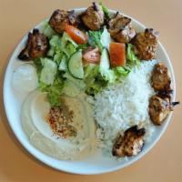 Chicken Kabob Plate · Marinated chicken breast pieces grilled on skewers with garlic sauce. Served with hummus, ri...