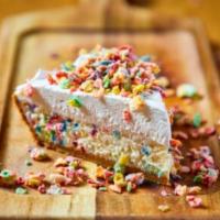 Fruity Pebbles Cheesecake · Funfetti cheesecake in a graham cracker crust topped with whipped cream and glazed fruity pe...