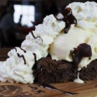 Brownie Sundae · Warm old fashioned brownie topped with either vanilla or chocolate ice cream. Finished with ...