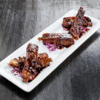 Crispy Ribs Plate · Tender St. Louis style pork ribs with BBQ sauce and a balsamic reduction drizzle.